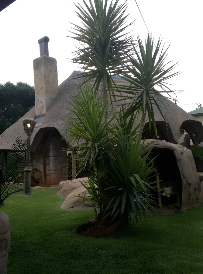 The garden dome with its curved thatched roof and stone chimney