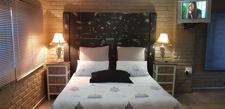 A double en-suite room with a dark wooden headboard