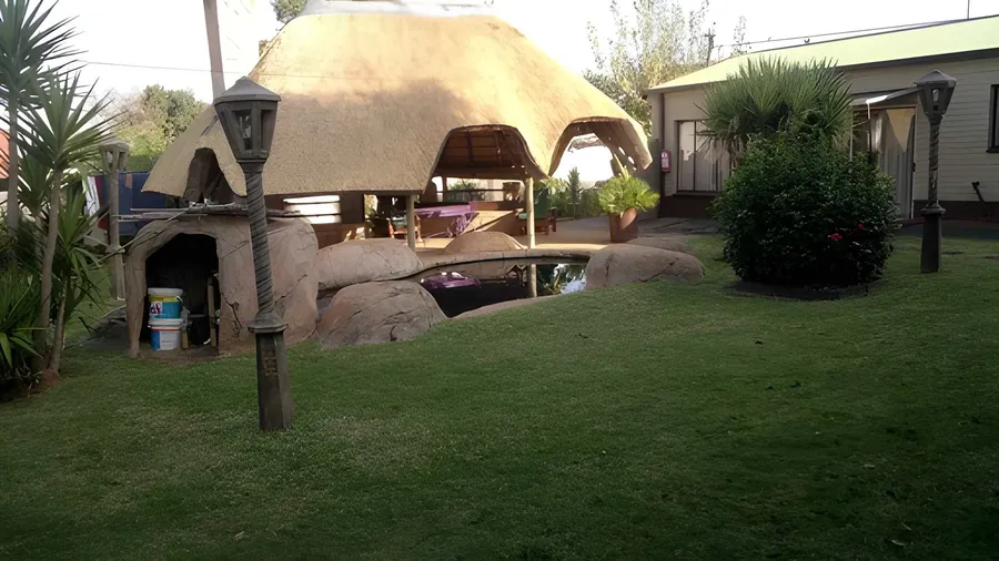 Thatched lapa and rock pool in the late afternoon sun
